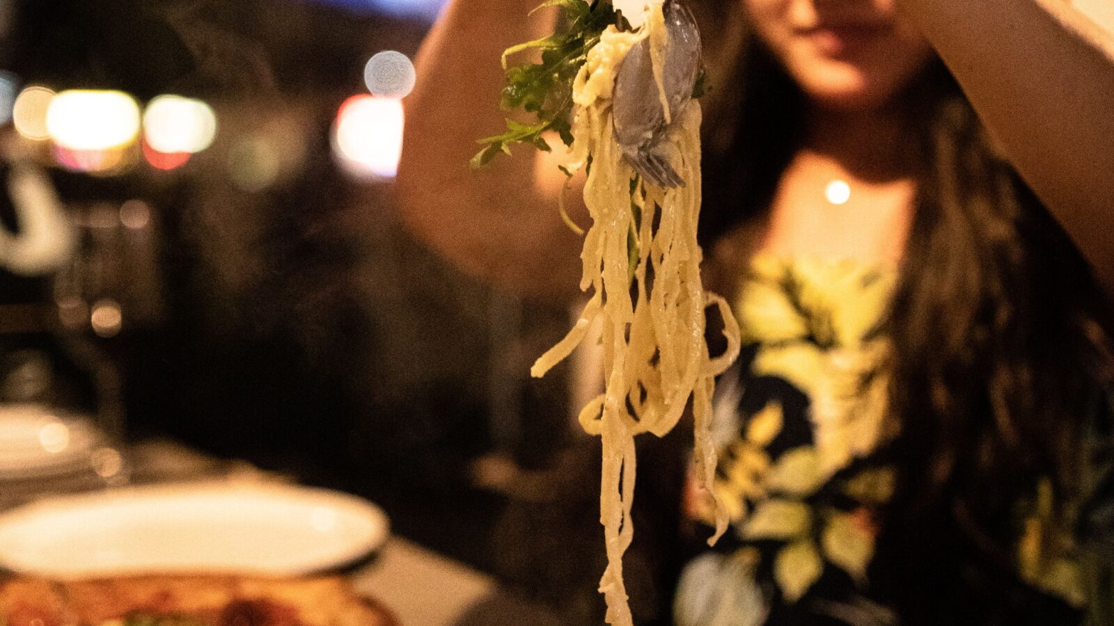 A woman eating handcrafted pasta at il Mercato, one of the best-rated Okanagan Valley Italian Restaurants